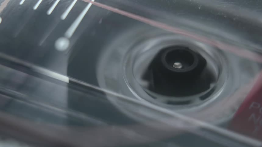 The wheel in a cassette tape spins around as it plays