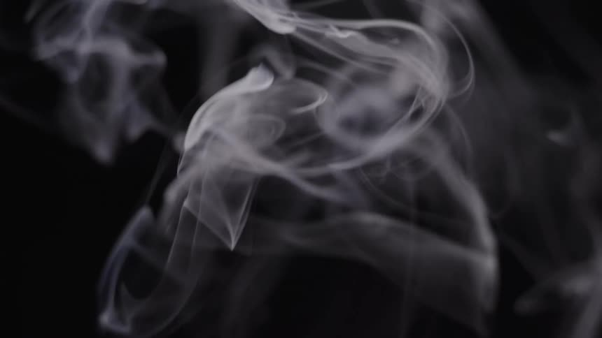 Smoke is floating upward in the darkness