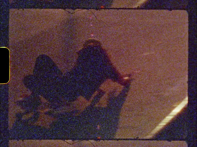 Woman skateboards on a skateboard ramp and uses her arm to turn herself around