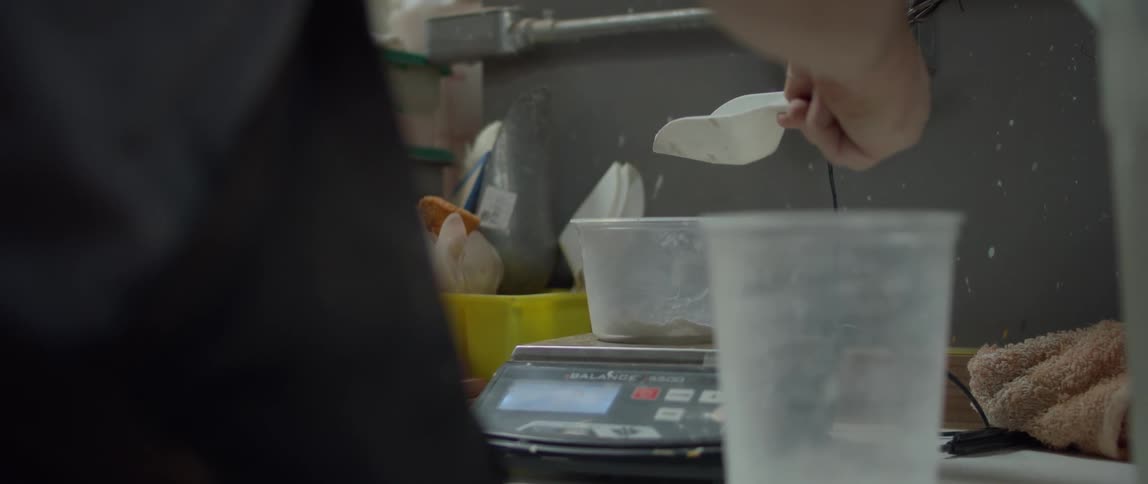 An employee measuring out materials