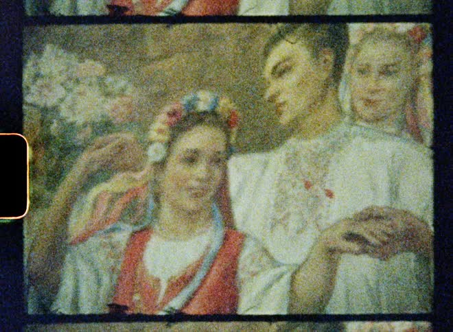 Vintage footage of a painting with people laughing