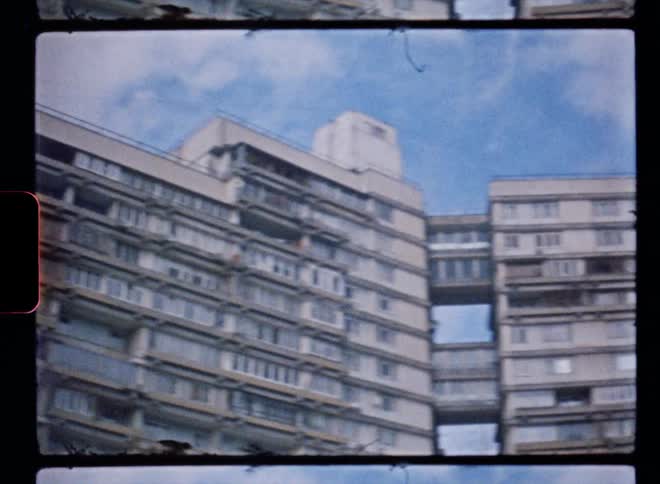 A vintage film of the exterior of a large office building