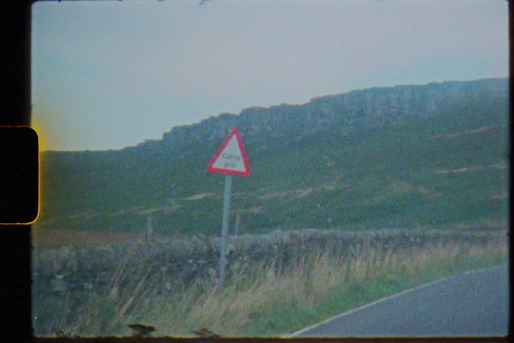 Vintage footage of a street sign in the countryside