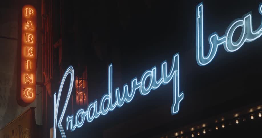 Neon signs on the facade of a building at night