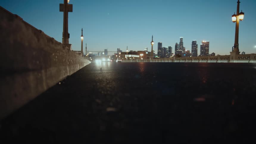 Vehicles are driving on the road by the city
