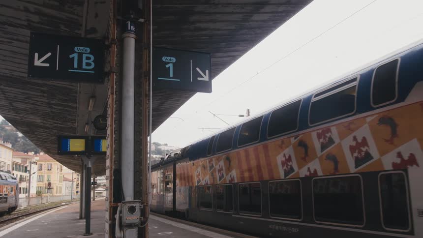 A train is arriving at the station during the day