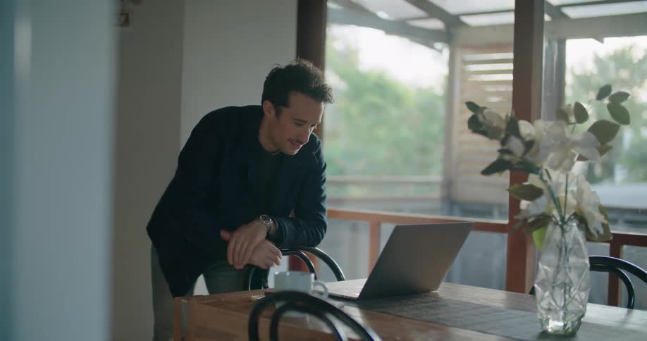 A man using a laptop while standing