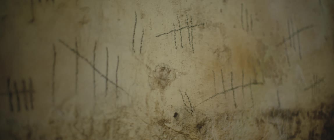 Tally marks on a dirty grimy wall