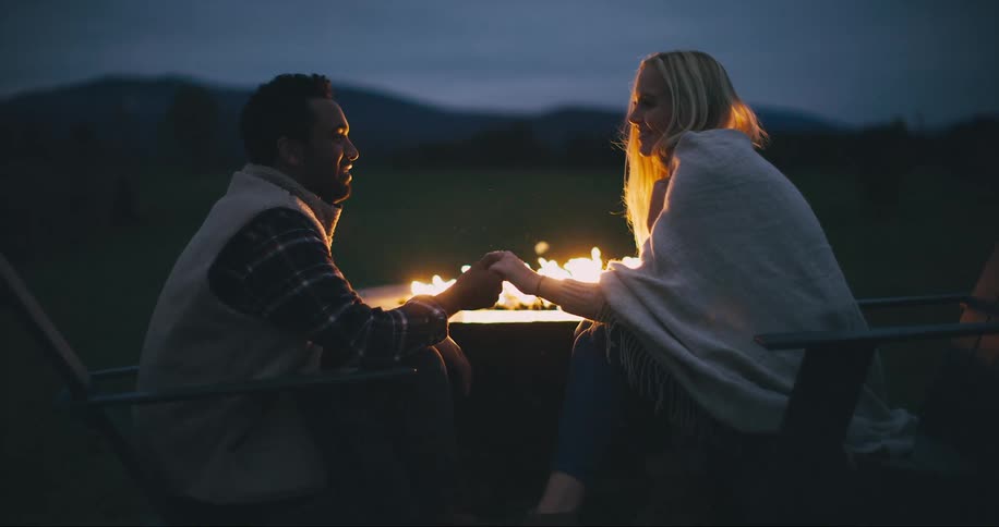 Couple share romantic moment by the fire