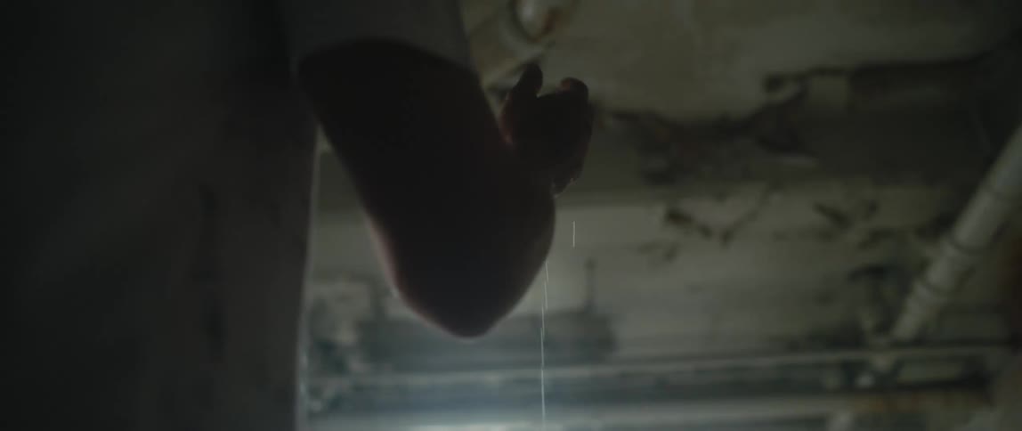 A plumber looking at a pipe in a house