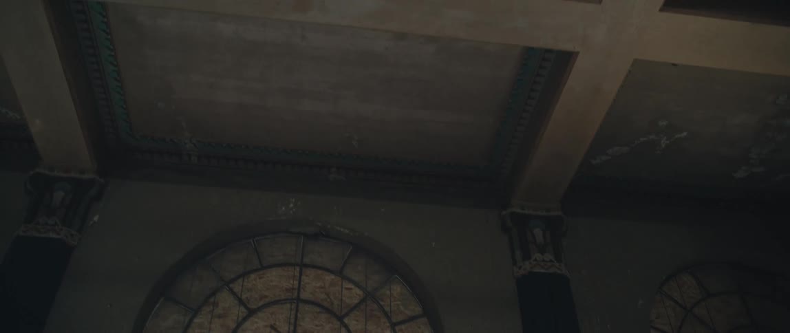 Wooden beams in a square pattern line the ceiling of a church