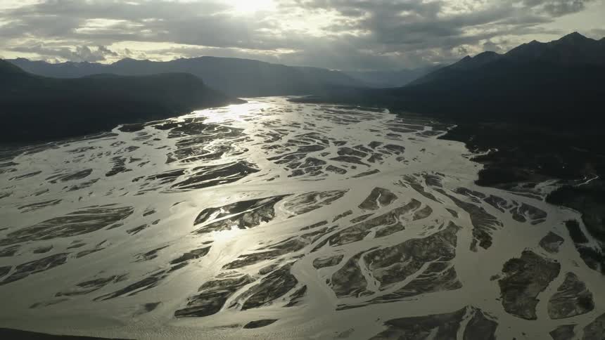 An aerial view of a lake near some mountains
