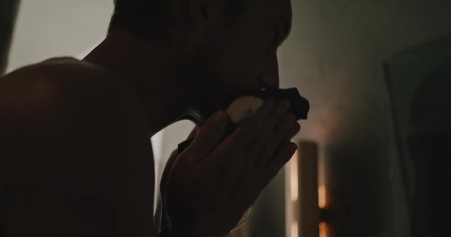A man wipes is face with a rag