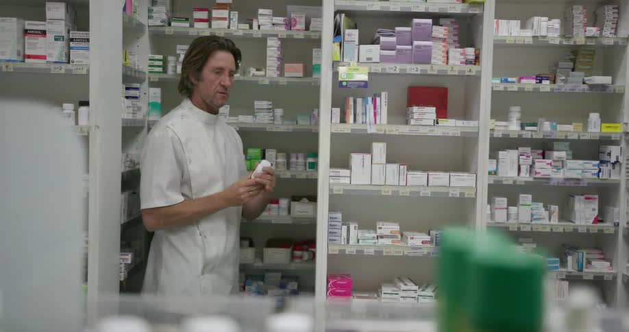 Man takes some medication from a shelf and walks away
