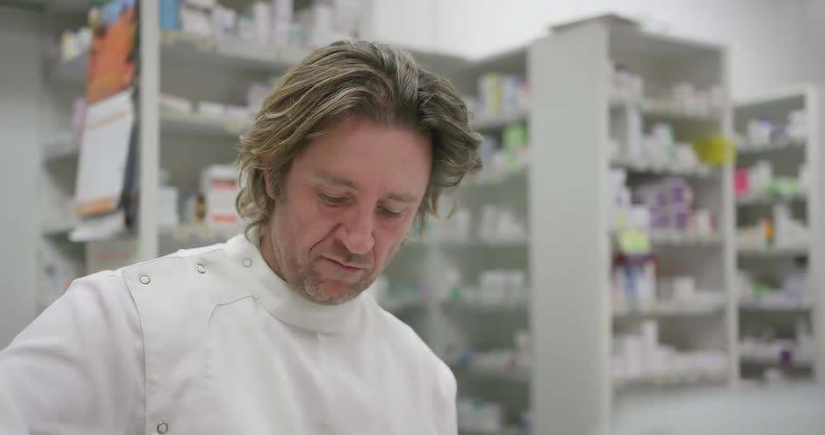 A pharmacist is mixing ingredients in a white bowl