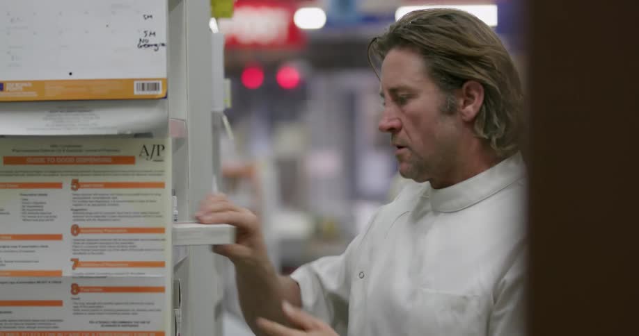 A pharmacist is looking through items