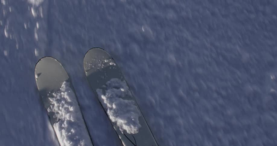 POV shot of skis turning in the snow