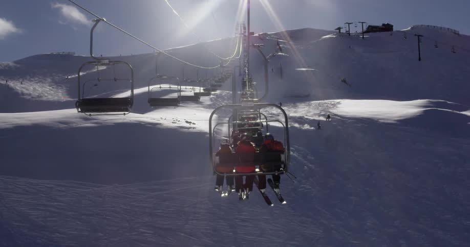 A ski lift is transporting people