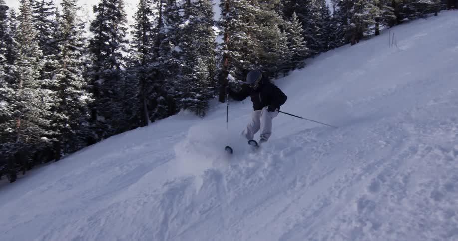Person skis quickly down a hill