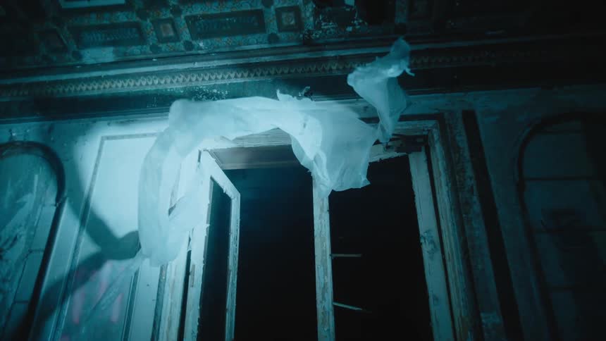 The wind blows the plastic on the broken window