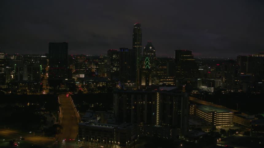 Lit up office buildings in a downtown area at night