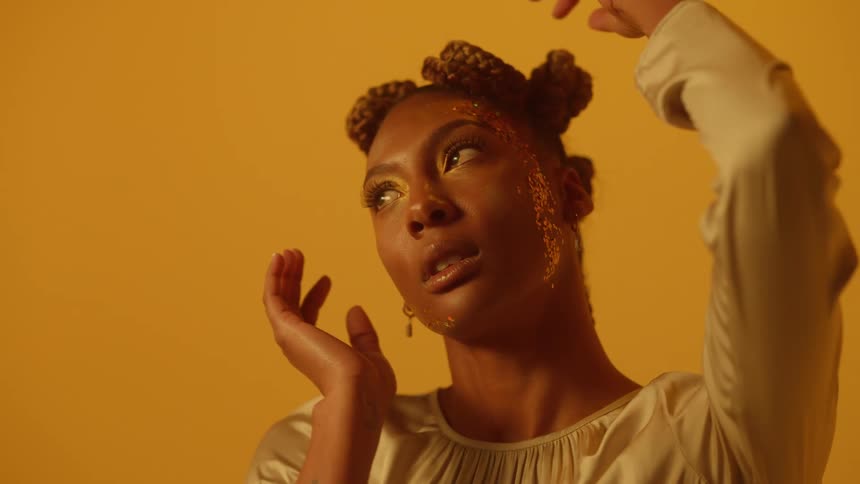 A woman is posing with her hands moving around
