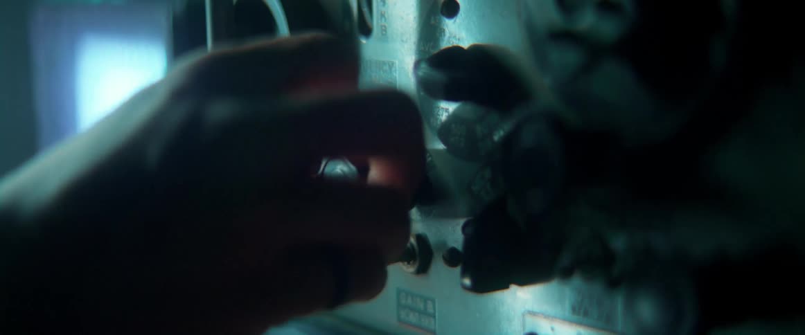 A person turns a dial on an amplifier