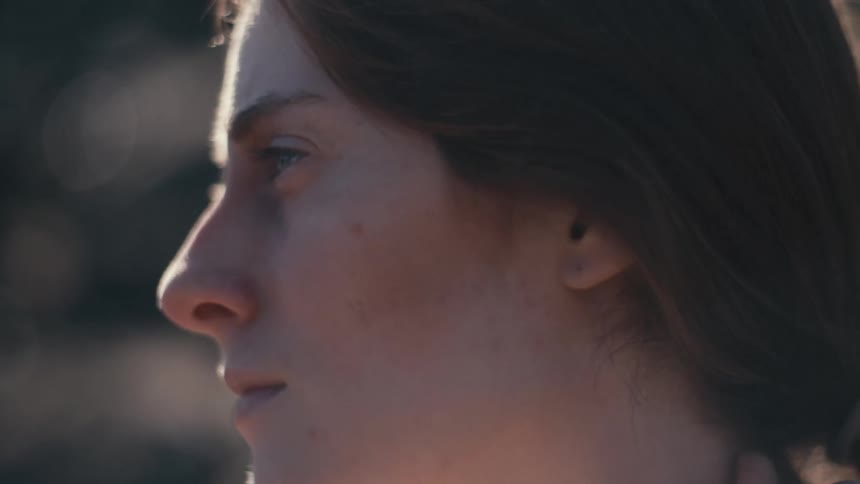 Close up of a hand as it strokes a teenage girls neck