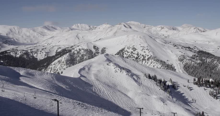 Aerial view of slopes with a ski lift below