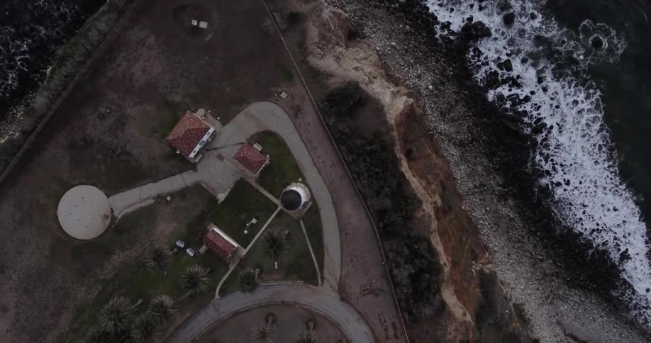 Aerial view of buildings next to a beach and water