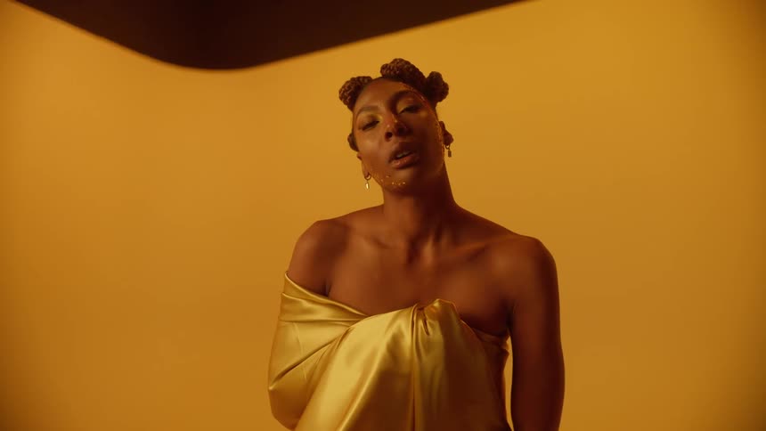 A woman is posing for the camera and is modeling