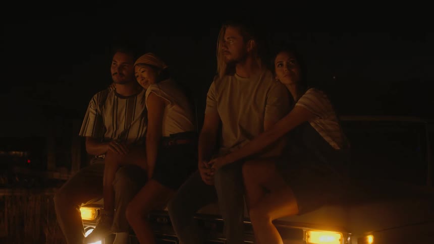 Two couples sitting outside at night