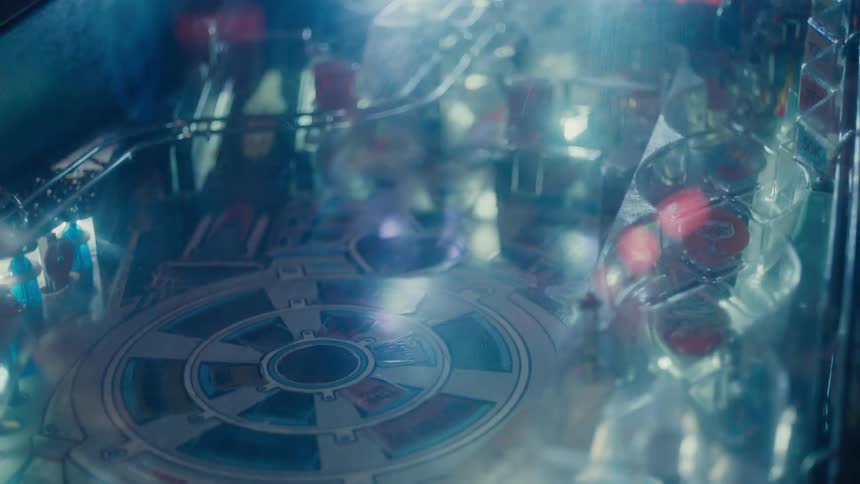 The lights flash on the pinball machine