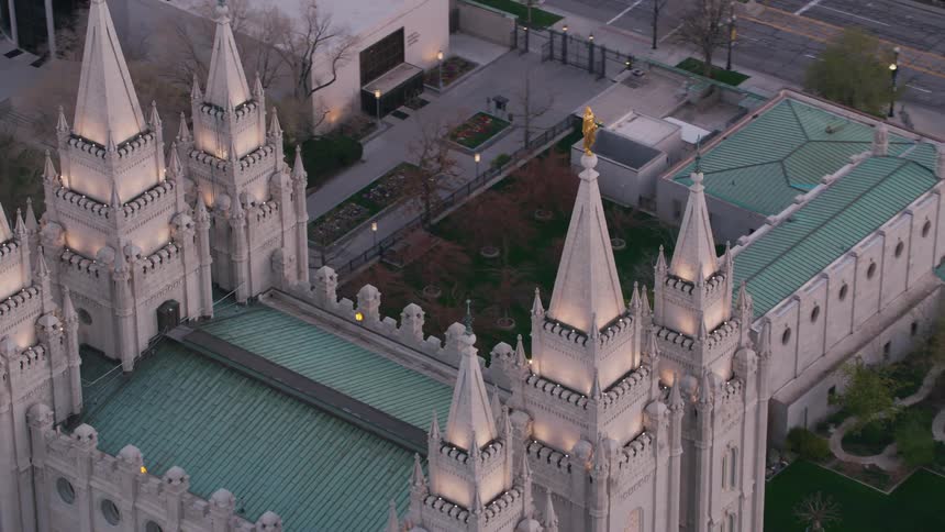 A gold statue is on top of a downtown building