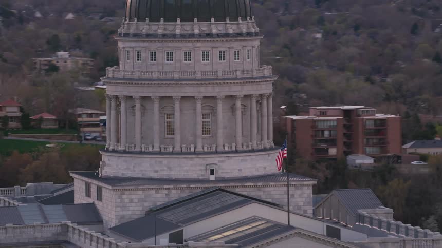 The flag is blowing on the building