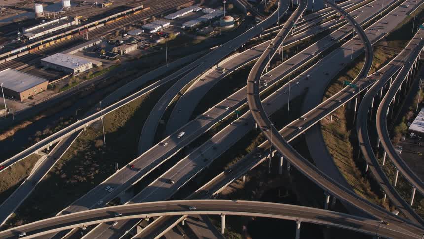 Aerial view of traffic flowing over the intersection of a highway in the city at morning