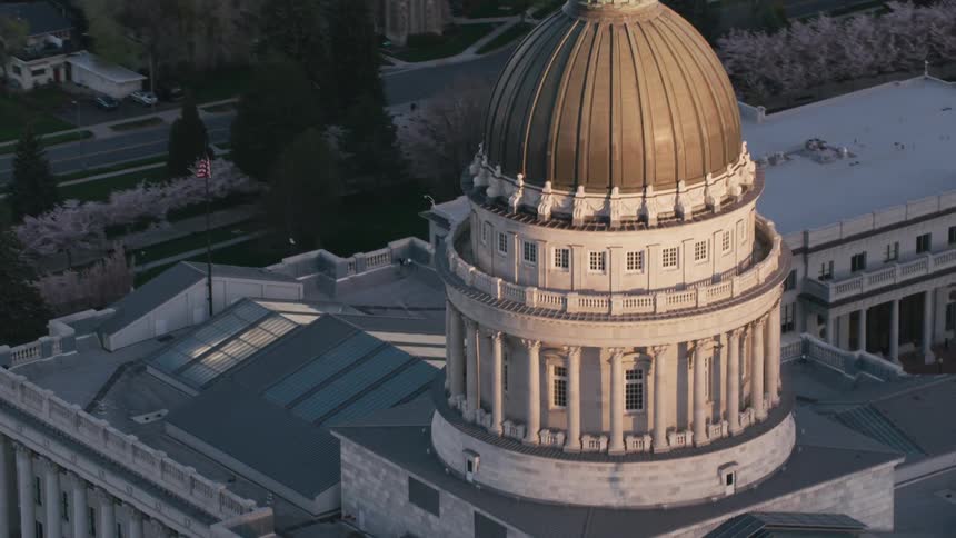 Aerial view of a capitol building in a downtown city is displayed