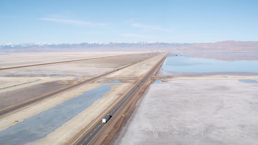 A truck drives down the long highway