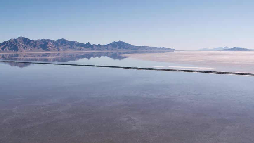 A canyon is reflected in a lake below