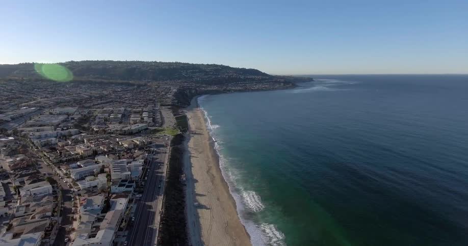 Aerial view of a coastline with a town nearby