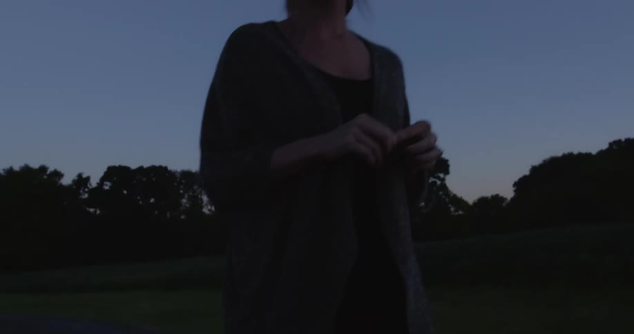 A woman his hiking outside at sunset