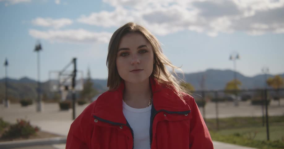 A woman is posing outside