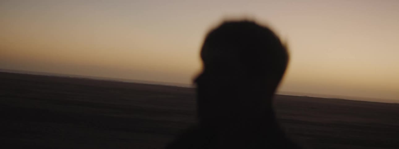 Walking through the desert at sunset