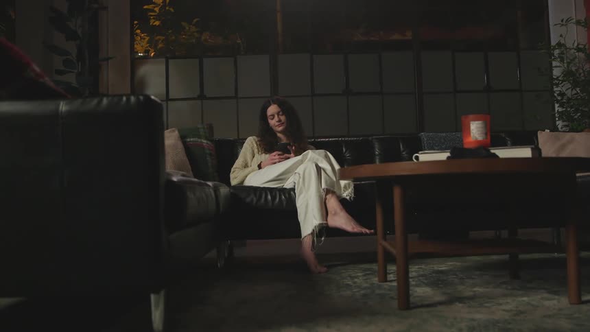 A woman rests on the couch