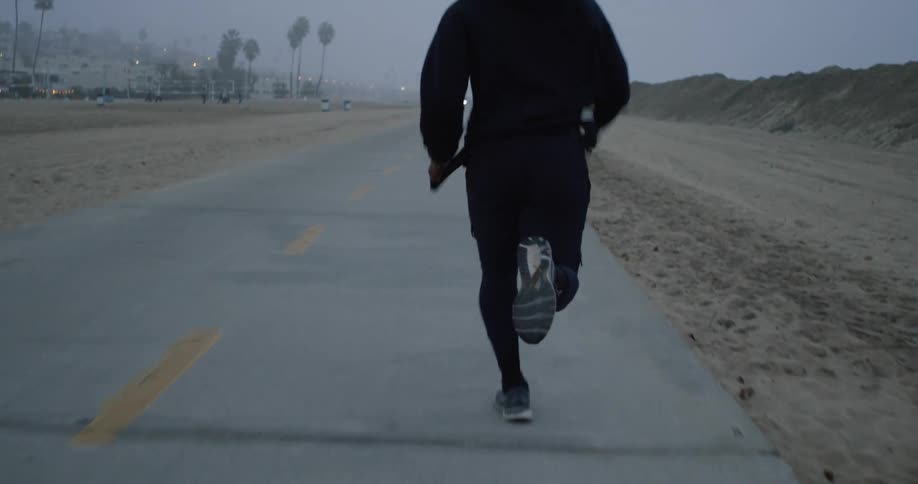 A man runs down a quiet road