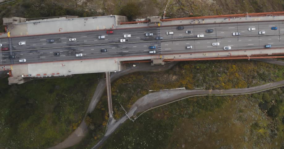 An aerial view of cars driving along the shore