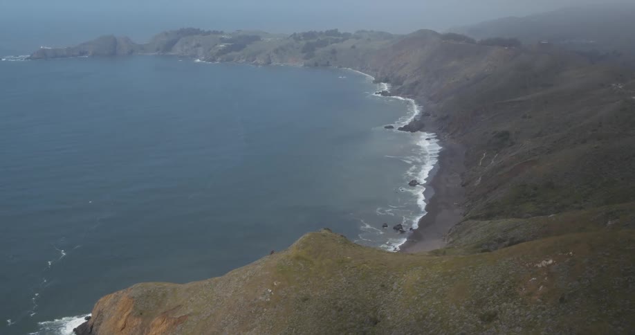 Sea waves crash onto the shore of a peninsula