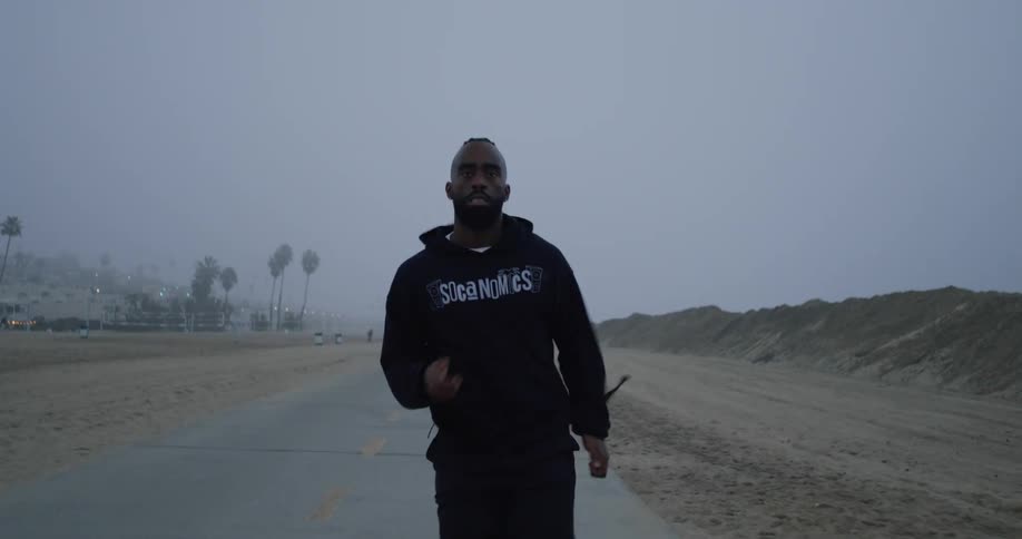 A black man is running on a rural road