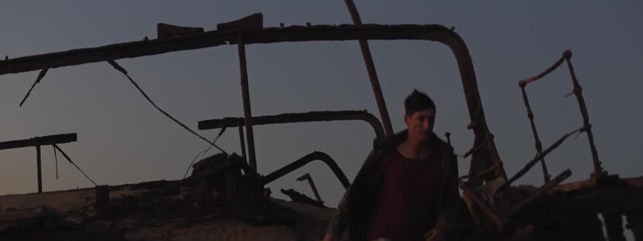 A man climbs down from the shipwreck