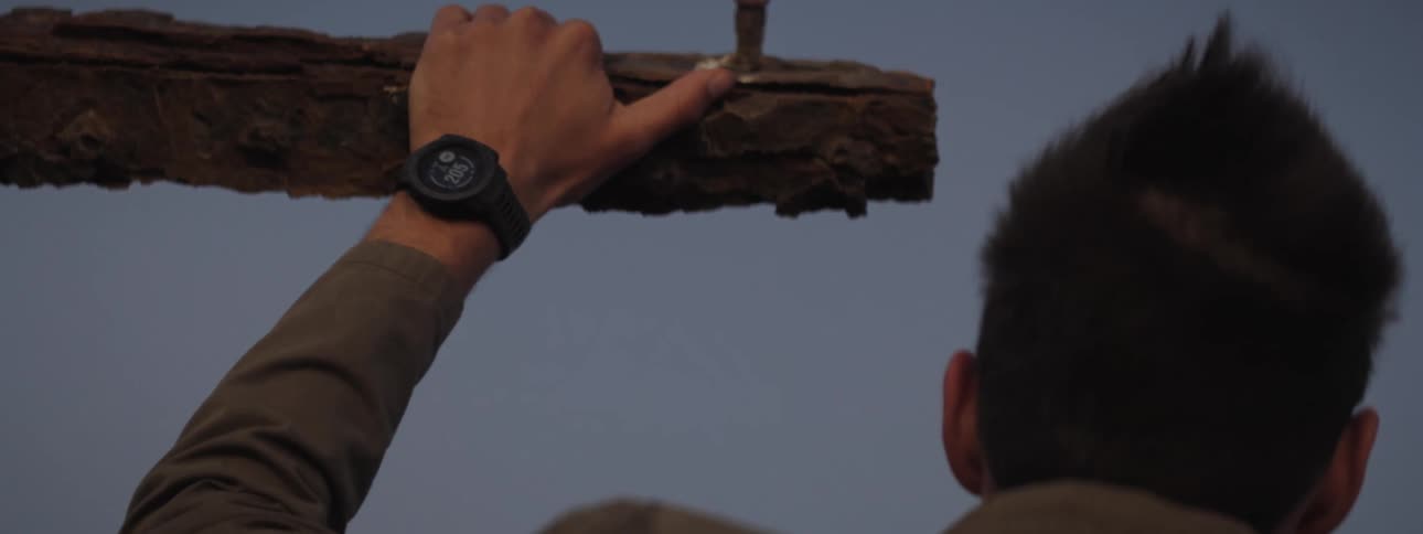 Close-up of man resting his hand on a rusted outpost on a shipwreck